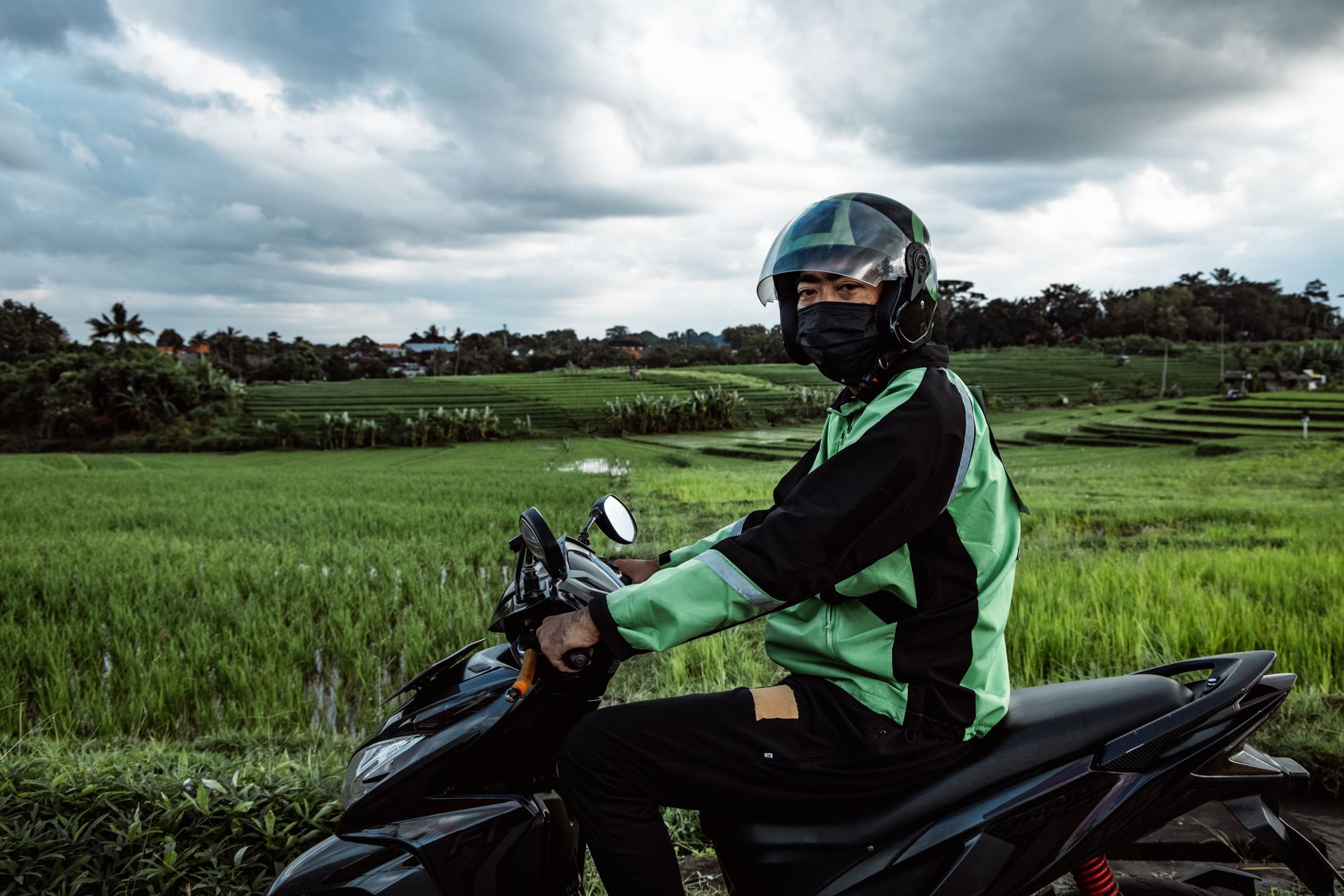 Motorbike parked near rice field